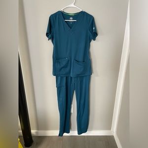Scrub set(teal blue) top is XS bottoms are S(long). Very soft material.